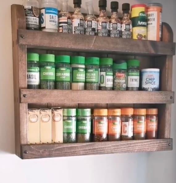 Hang a spice rack on ⁣a wall to clear small kitchen counters